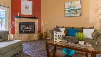 Estancia cozy clubhouse with couches and a fireplace